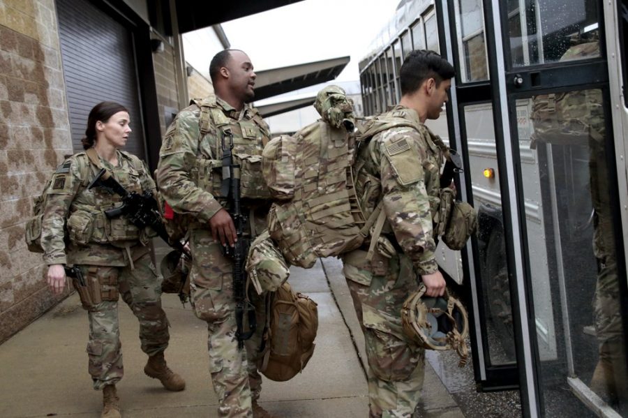 U.S. Army soldiers with their gear board an awaiting bus Saturday, Jan. 4, 2020 at Fort Bragg, N.C., as troops from the 82nd Airborne are deployed to the Middle East as reinforcements in the volatile aftermath of the killing of Iranian Gen. Qassem Soleimani. (AP Photo/Chris Seward)